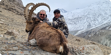 Hunter with bukhara ibex hunts trophy